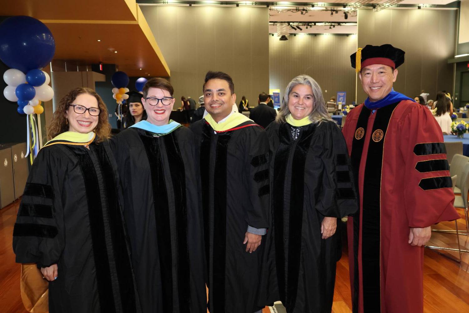 CIDS Deans and Faculty wearing gowns at graduation ceremony